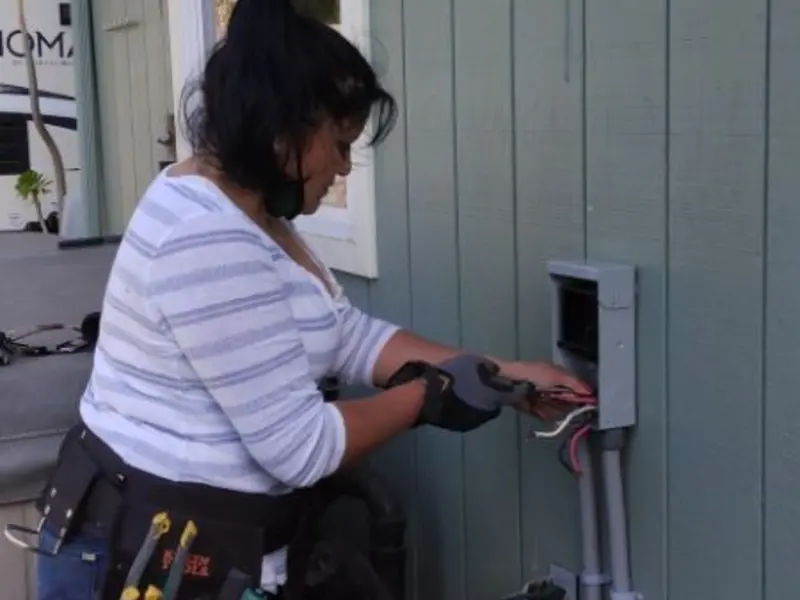 Licensed electrician wiring an exterior subpanel in Silvis