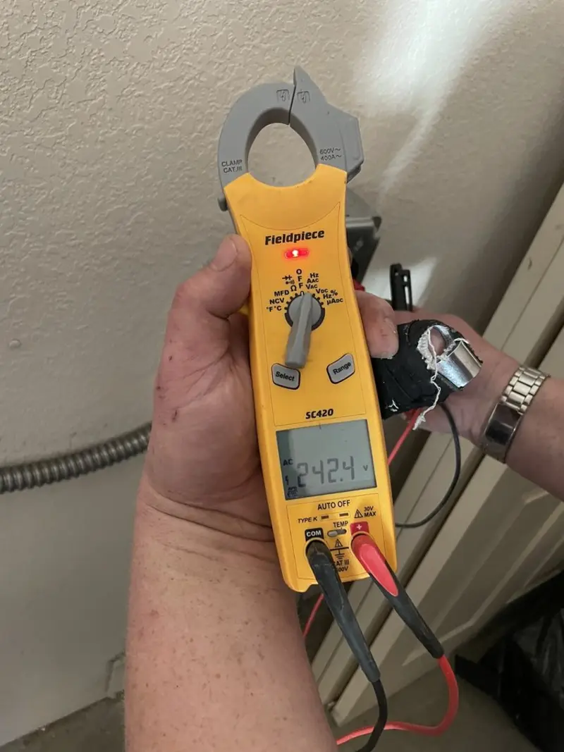 Voltage testing with clamp meter during Electrical Installation Services in Silvis